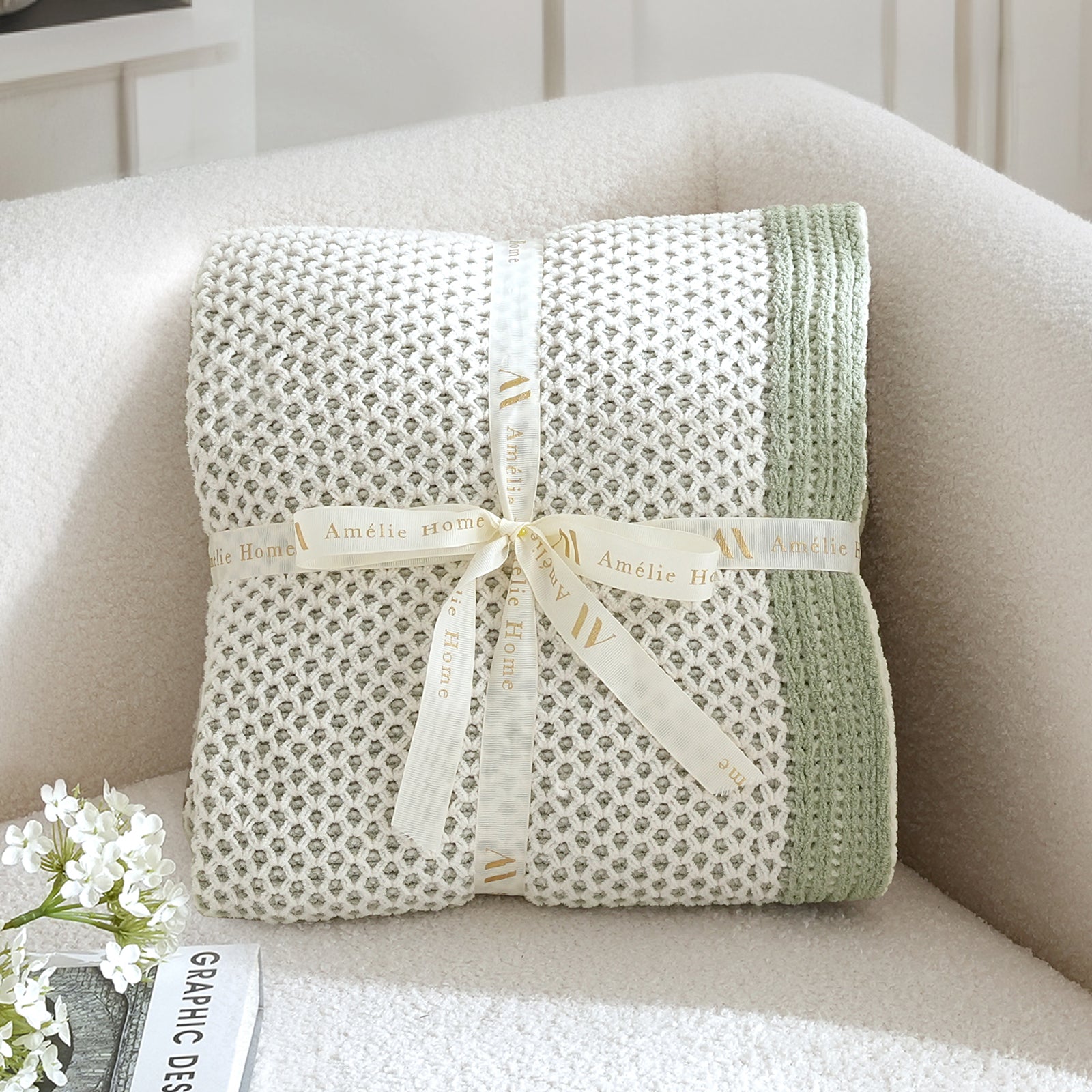 Green textured blanket with a ribbon on a beige armchair #color_Sage Green