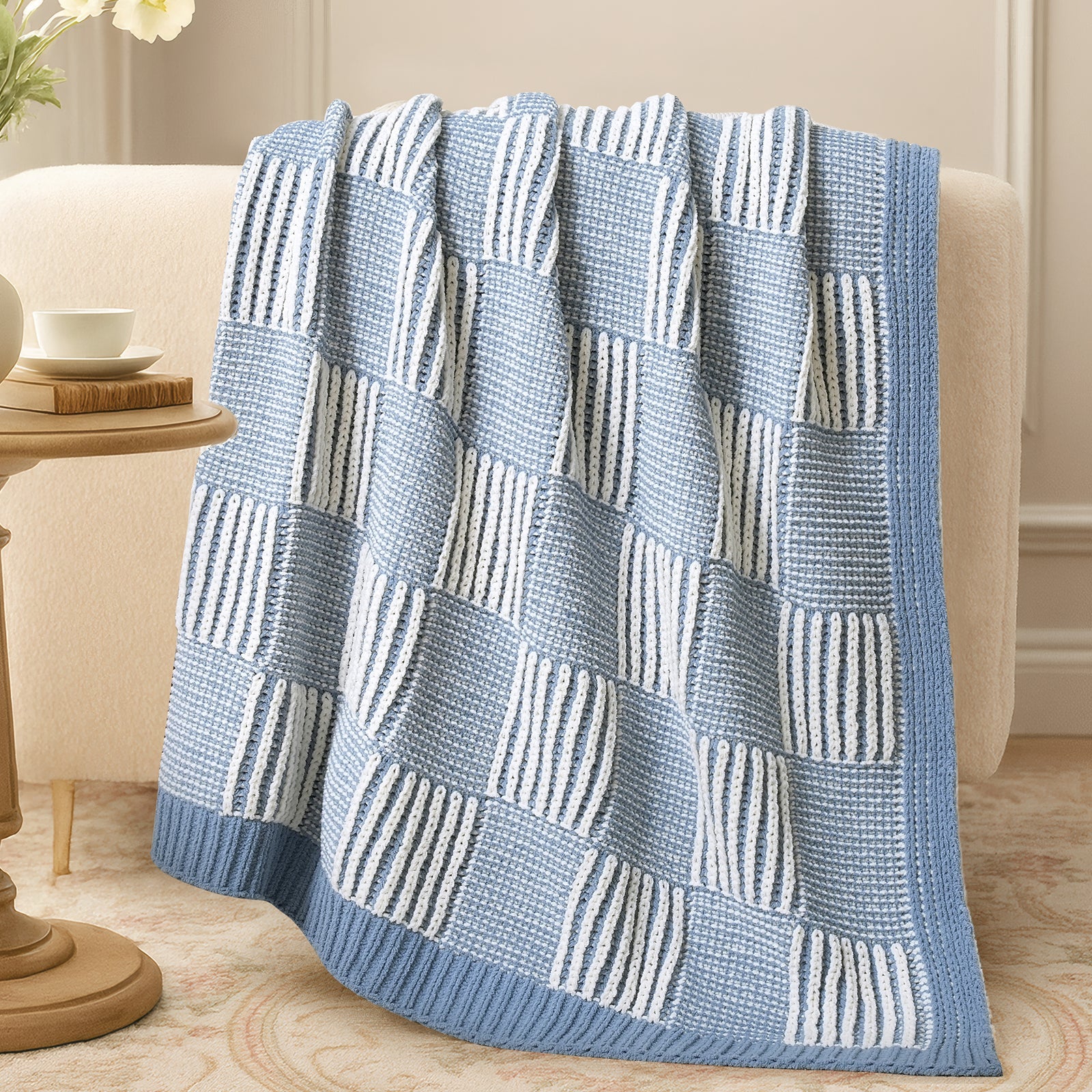 Two tone checkered chenille knit throw blanket in Blue draped over sofa creating a warm and inviting look #color_Blue