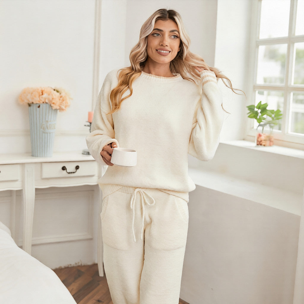Woman in a cream-colored outfit standing in a bedroom. #color_Ivory